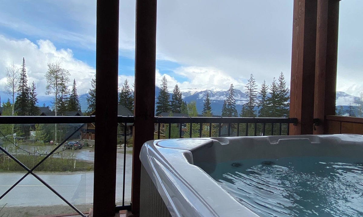Golden House | Mountain views from hot tub in this 3br/2bath ski/bike in home at Kicking Horse