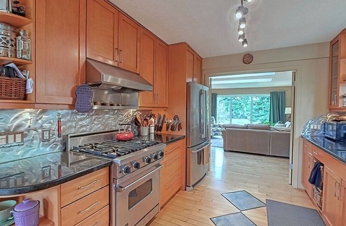 Northwest Calgary House | Almost 1/2 an acre on the Bow River, huge fenced yard, hot tub, firepit, games!