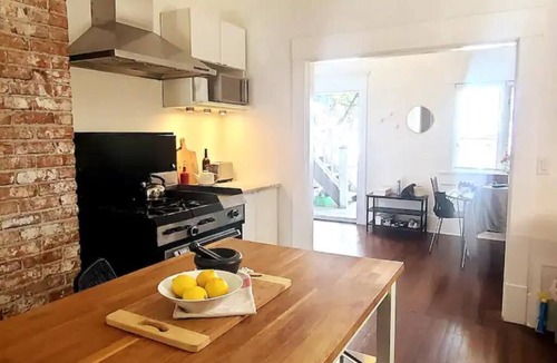 East Side House | Design Heritage Suite | Brick + Private Patio near Commercial Drive