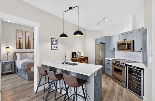 Westbank Apartment | Escape to The Cove Lakeside Resort in this beautifully renovated ground-floor 2-bed, 2-bath condo. Features a huge walk-out patio with a private gate, cozy outdoor seating, and direct access to the pool, beach, marina, and waterfront trails.
