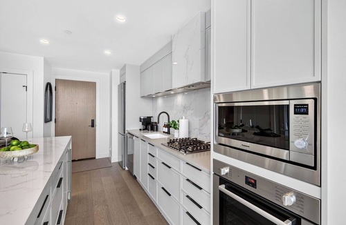 South Pandosy Condo | Experience luxury lakefront living at AQUA Kelowna. This elegant 1-bed retreat features a king suite & soa bed, spa-inspired bath, designer kitchen, and private patio with stunning Okanagan Lake views, plus resort pool/gym access.