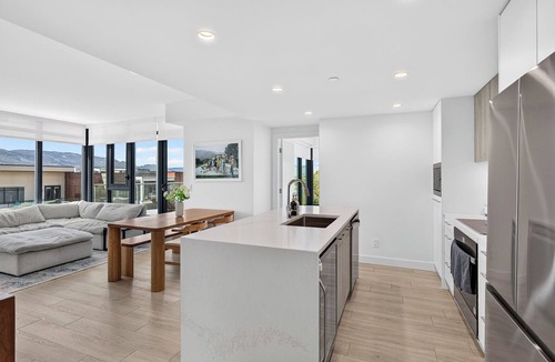 South Pandosy Apartment | Experience luxury waterfront living at Aqua Waterfront Village. This stylish 2BR, 2BA condo features designer interiors, two queen bedrooms, a spacious covered patio, chef's kitchen, and resort-style amenities just steps from Okanagan Lake.
