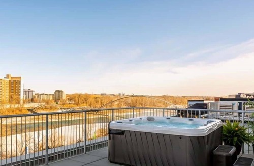 East Village Apartment | Private Hot Tub, River Views, Walk to Stampede