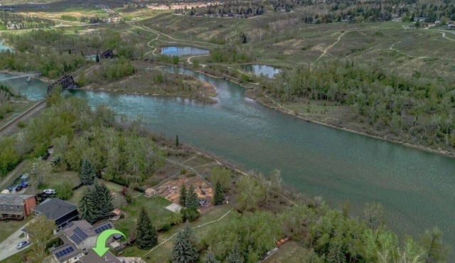 Almost 1/2 an acre on the Bow River, huge fenced yard, hot tub, firepit, games!