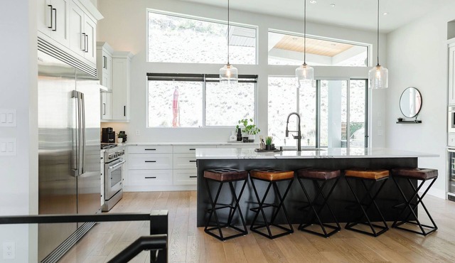 Designer home above McKinley Beach with sweeping lake views, private hot tub, putting green, Traeger smoker, pool or ping pong, & chef kitchen with JennAir. Three bedrooms sleep 6 comfortably, plus sofa bed for 2. Quiet community, 15 min to downtown.