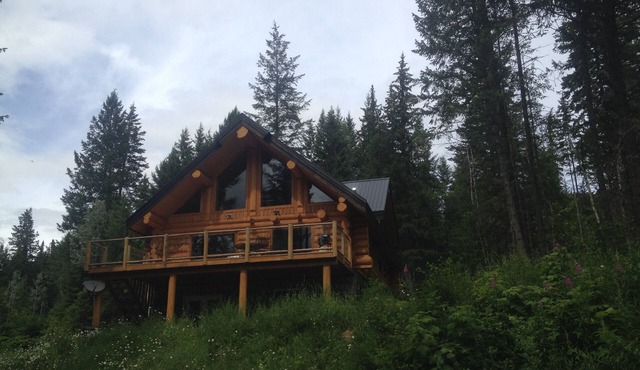 Golden Log House above the Valley