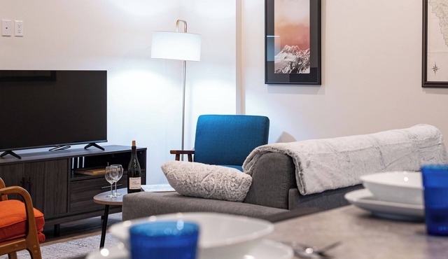 Spacious Revelstoke rental near ski hill and downtown, with private hot tub, full kitchen, and comfortable living areas for up to 5 guests.