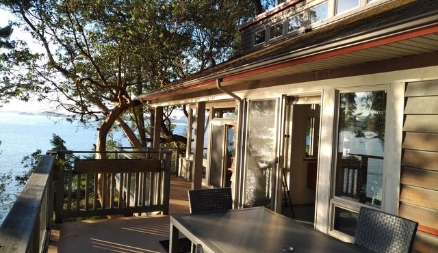 Waterfront home with stunning views, surrounded by nature.